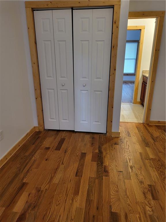 1167 Oakland Dr SW, Atlanta, GA 30310 - unfurnished bedroom with baseboards, light wood-style floors, and a closet