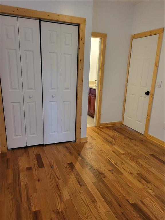 1167 Oakland Dr SW, Atlanta, GA 30310 - unfurnished bedroom featuring light wood-type flooring, a closet, baseboards, and ensuite bath
