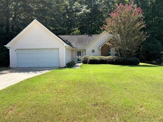 single story home with a garage and a front lawn