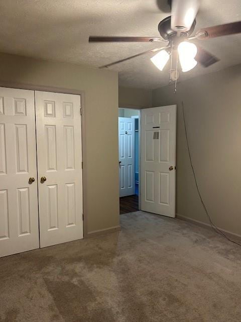 unfurnished bedroom featuring ceiling fan, a closet, and carpet floors