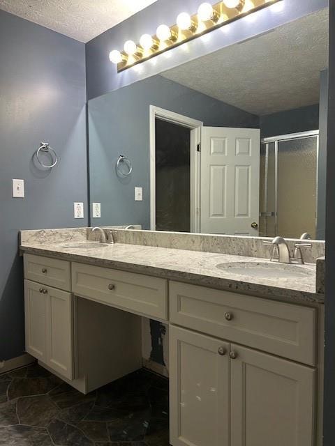 bathroom featuring vanity, an enclosed shower, and tile patterned floors