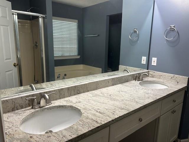 bathroom featuring shower with separate bathtub and vanity