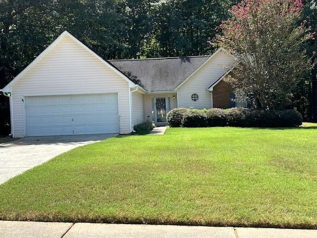 single story home with a garage and a front lawn