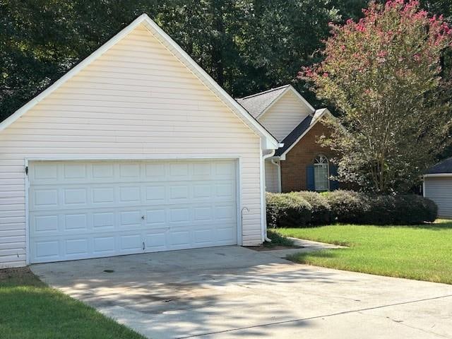 exterior space featuring a lawn and a garage