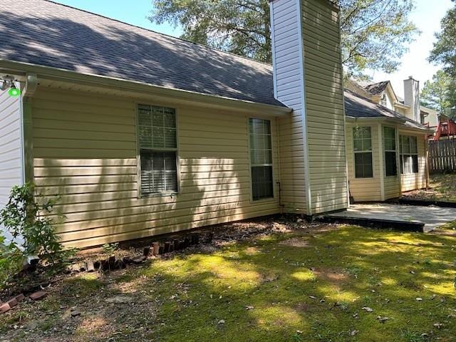 rear view of house featuring a yard