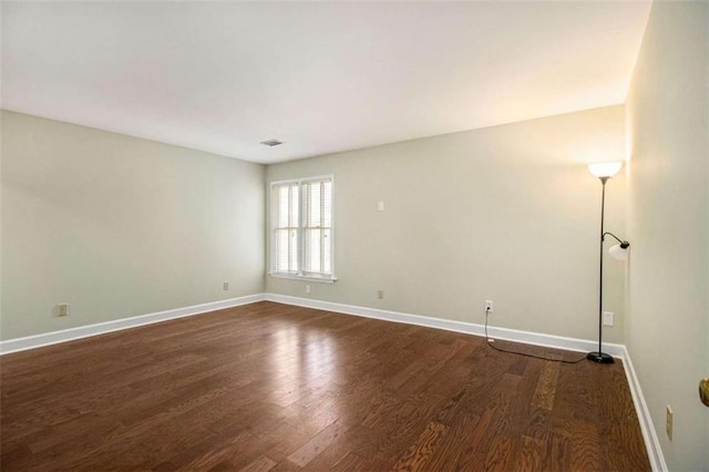 1484 Winston Pl, Decatur, GA 30033 - empty room with visible vents, baseboards, and dark wood-style flooring
