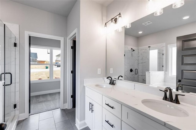 bathroom featuring tile patterned flooring, vanity, and an enclosed shower