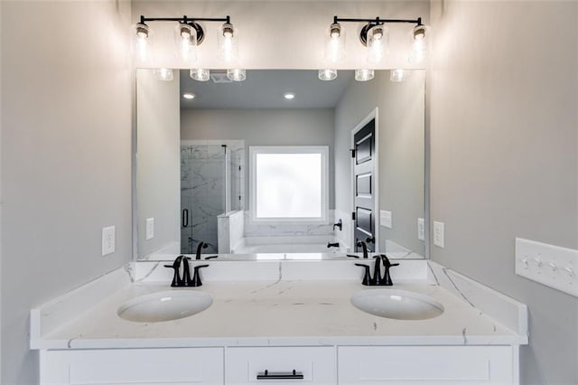 bathroom featuring vanity and independent shower and bath