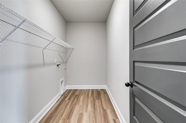 clothes washing area with hardwood / wood-style floors, washer hookup, and hookup for an electric dryer