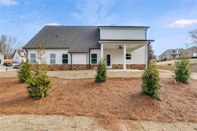 rear view of house featuring ceiling fan and a patio area