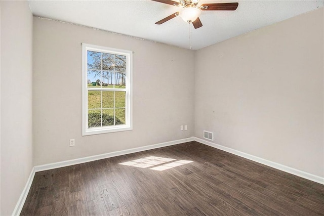 empty room featuring ceiling fan and dark hardwood / wood-style flooring