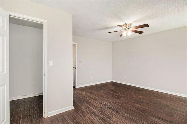 spare room with ceiling fan, dark hardwood / wood-style flooring, and a textured ceiling