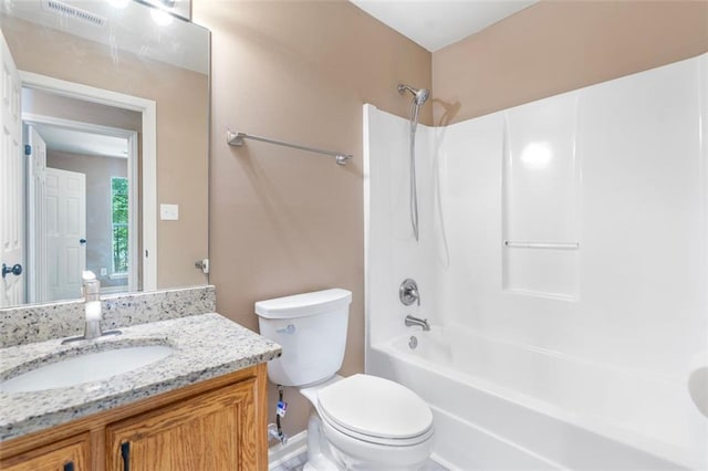 bathroom with toilet, bathing tub / shower combination, vanity, and visible vents