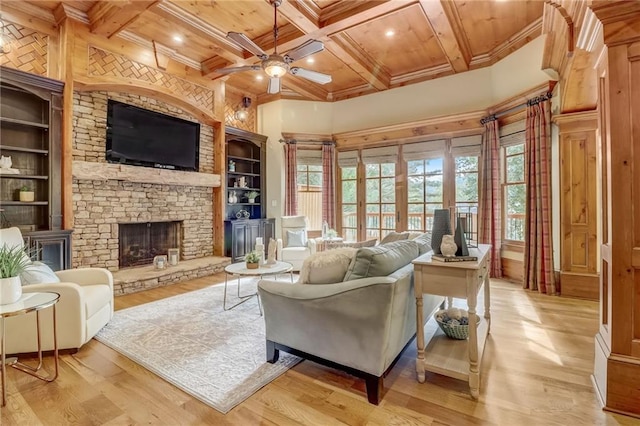 living room featuring coffered ceiling, a stone fireplace, wood ceiling, light wood-type flooring, and ceiling fan