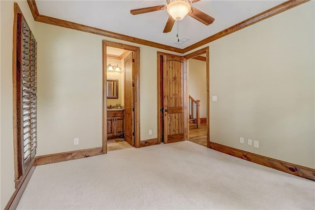 unfurnished bedroom featuring light carpet, connected bathroom, crown molding, and ceiling fan