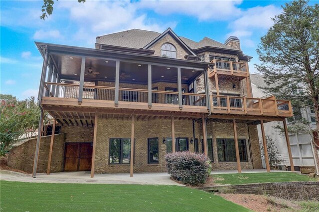 back of property featuring a patio area, ceiling fan, and a lawn