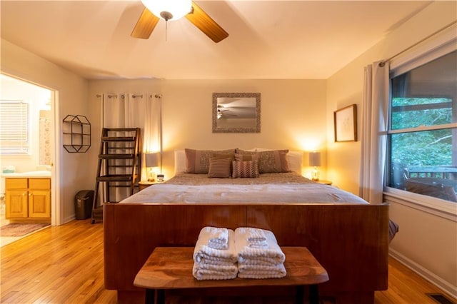 bedroom featuring ensuite bathroom, ceiling fan, and light hardwood / wood-style floors