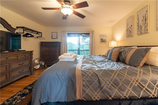 bedroom featuring ceiling fan, wood-type flooring, and access to exterior