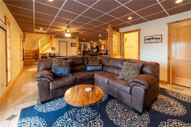 living room featuring a paneled ceiling