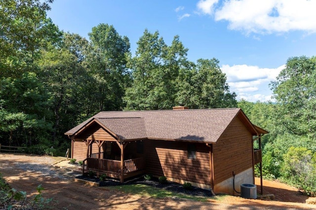 view of front of house with a wooden deck and central AC unit