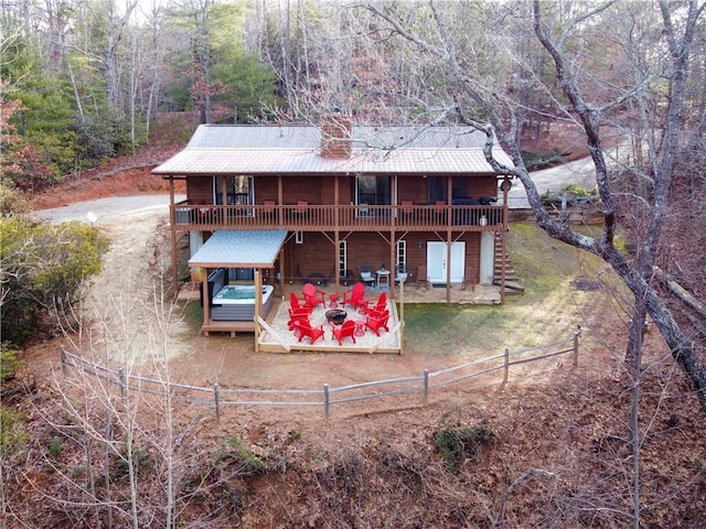 rear view of house featuring a deck