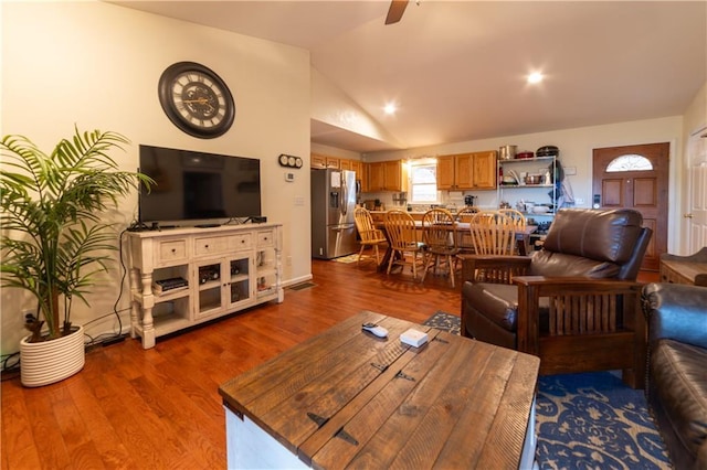 living room featuring lofted ceiling, light hardwood / wood-style floors, and ceiling fan