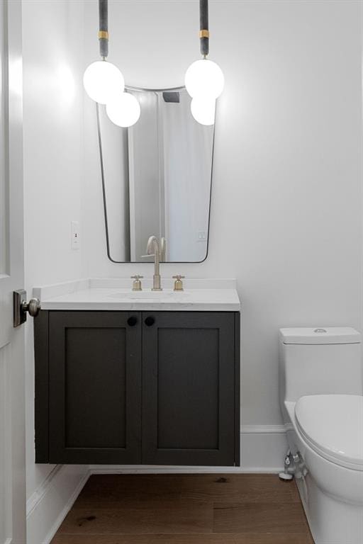 bathroom featuring hardwood / wood-style floors, toilet, and vanity