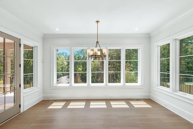 unfurnished sunroom featuring plenty of natural light and an inviting chandelier