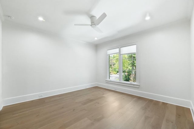 unfurnished room featuring hardwood / wood-style floors and ceiling fan