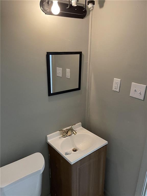 bathroom featuring vanity and toilet