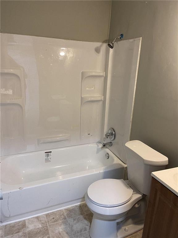 full bathroom with vanity, toilet, and shower / tub combination