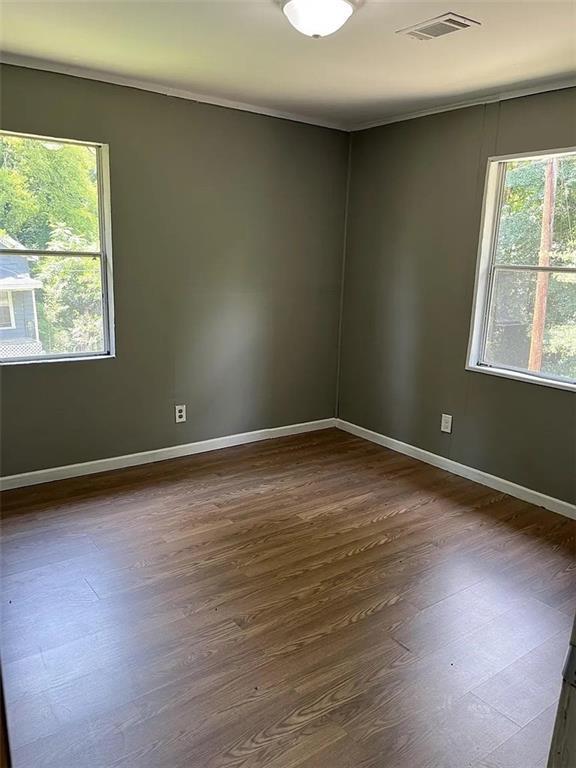 spare room with dark hardwood / wood-style floors