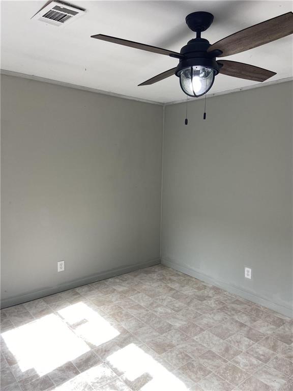 spare room with ceiling fan