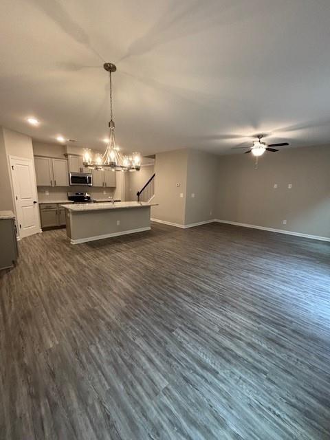 dining space featuring ceiling fan with notable chandelier and a baseboard radiator