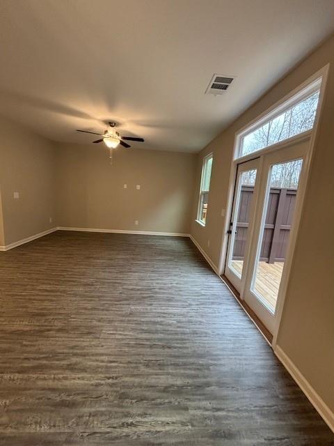 living room featuring ceiling fan with notable chandelier and french doors