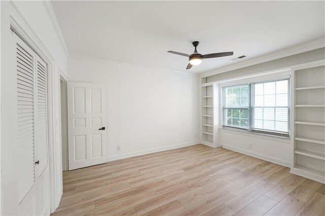 3649 Peachtree Rd NE Unit 305, Atlanta, GA 30319 - unfurnished bedroom featuring light wood-style flooring, ornamental molding, baseboards, a ceiling fan, and a closet