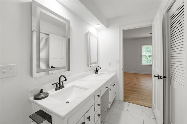 3649 Peachtree Rd NE Unit 305, Atlanta, GA 30319 - bathroom featuring double vanity, marble finish floors, and baseboards