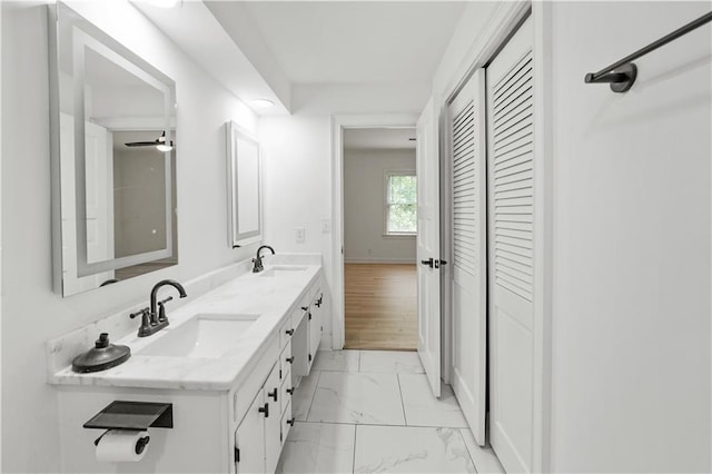 3649 Peachtree Rd NE Unit 305, Atlanta, GA 30319 - full bathroom with marble finish floors, a closet, double vanity, and baseboards