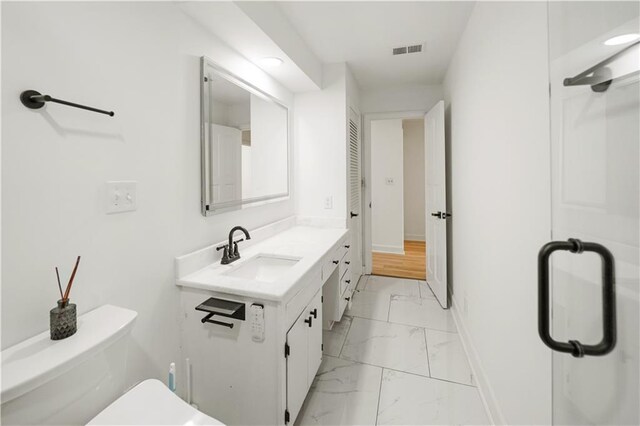 3649 Peachtree Rd NE Unit 305, Atlanta, GA 30319 - bathroom with marble finish floors, vanity, toilet, and baseboards