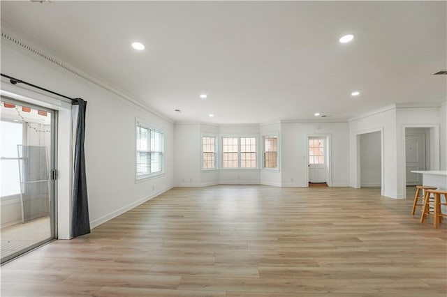 3649 Peachtree Rd NE Unit 305, Atlanta, GA 30319 - unfurnished living room featuring crown molding, healthy amount of natural light, recessed lighting, light wood-style flooring, and baseboards