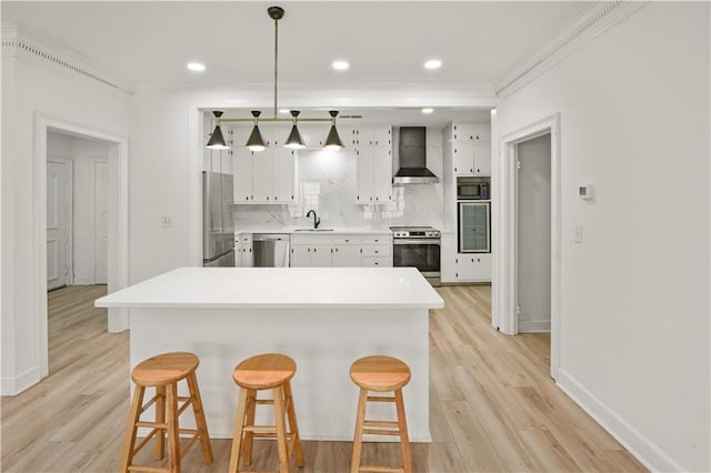 3649 Peachtree Rd NE Unit 305, Atlanta, GA 30319 - kitchen with appliances with stainless steel finishes, wall chimney exhaust hood, a sink, crown molding, and a kitchen breakfast bar