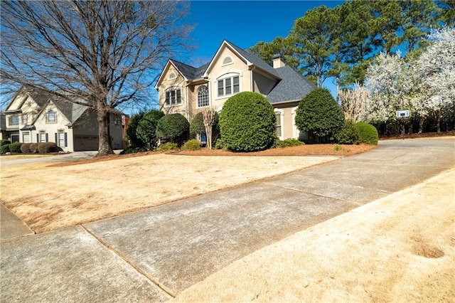 view of front of property featuring a chimney and stucco siding