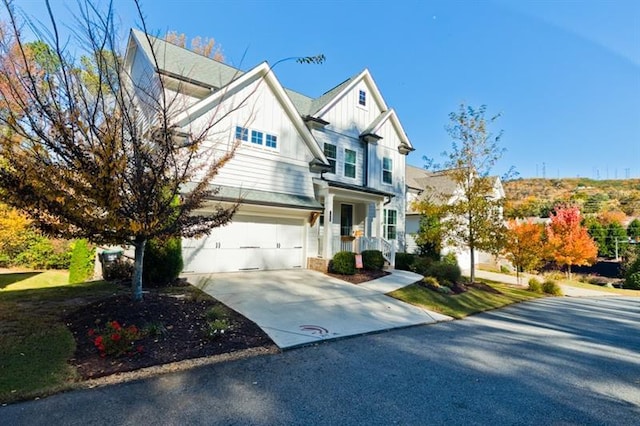 view of front of property with driveway, an attached garage, and board and batten siding