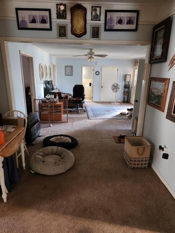 living room featuring baseboards, carpet floors, and ceiling fan