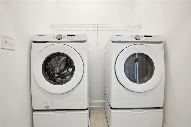 laundry room with light tile patterned flooring and independent washer and dryer