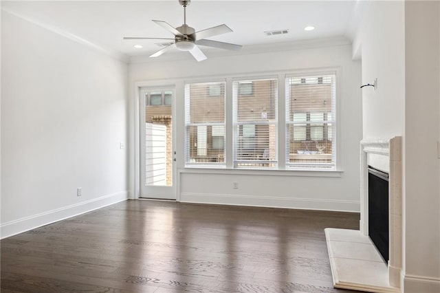 unfurnished living room featuring a wealth of natural light, crown molding, dark hardwood / wood-style floors, and ceiling fan