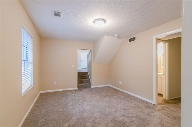 1841 Northwick Pl, Lithonia, GA 30058 - additional living space with light colored carpet and a textured ceiling