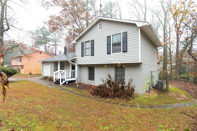 1841 Northwick Pl, Lithonia, GA 30058 - view of front facade featuring central AC unit, a front yard, and a garage