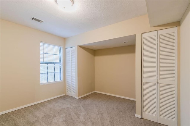1841 Northwick Pl, Lithonia, GA 30058 - unfurnished bedroom with two closets, a textured ceiling, and light colored carpet