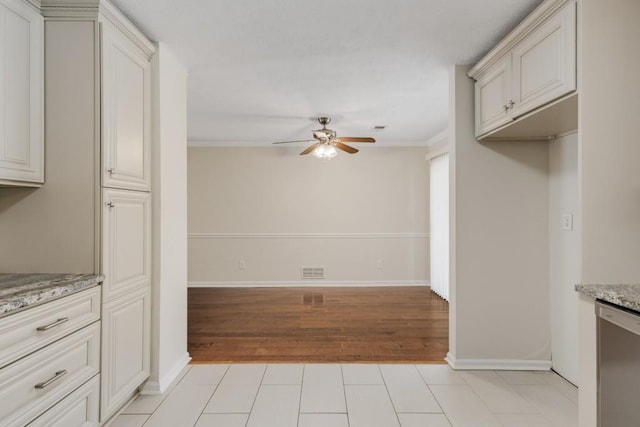 kitchen with light stone counters, a ceiling fan, visible vents, light tile patterned flooring, and stainless steel dishwasher